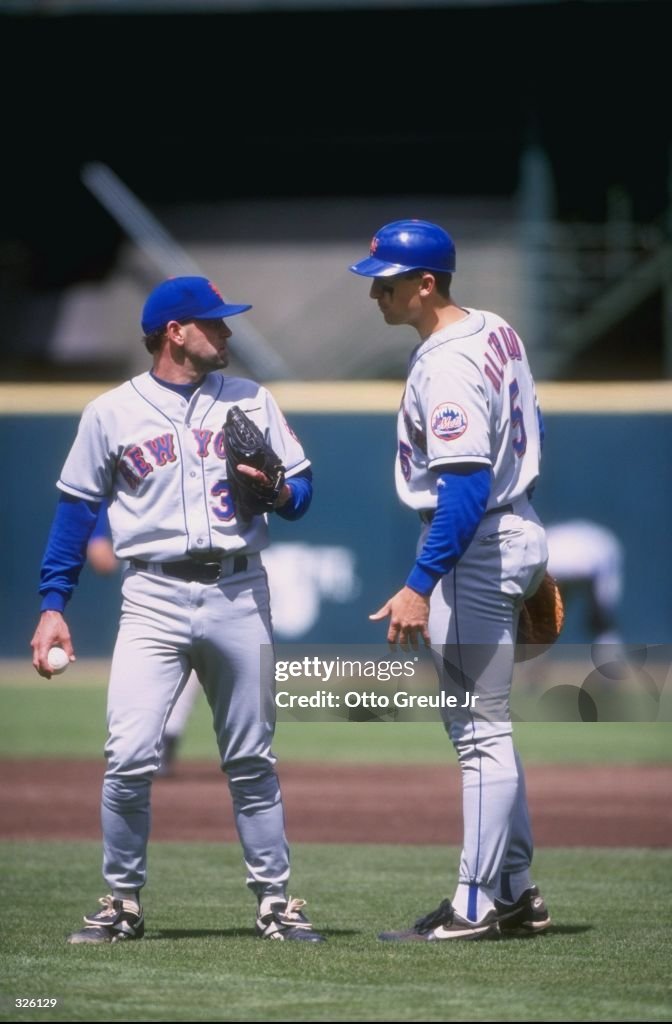 Rick Reed Mets Card Pitcher Rick Reed of the New York Mets talks to infielder John Olerud ...
