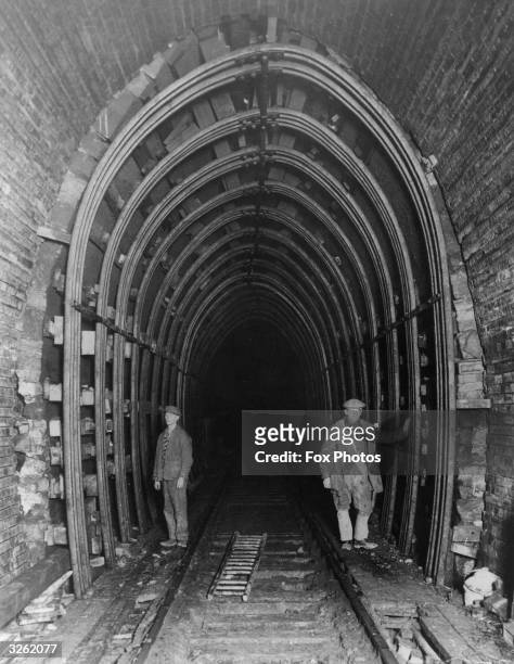 Miners repair the 80 year old sandstone and brick tunnel at Whitehaven, Cumberland with old rails being used for support.