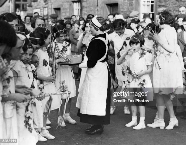 Derbyshire girls take a break from dancing around the Maypole.