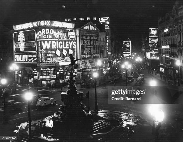 Illuminated signs dominate Piccadilly Circus at night.