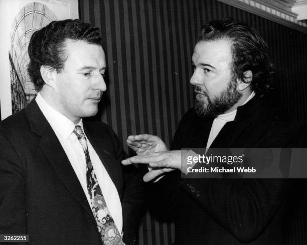 Sir Colin Rex Davis, English conductor of the BBC Symphony Orchestra and Director at Covent Garden, London, talking to Peter Hall, producer at Covent...