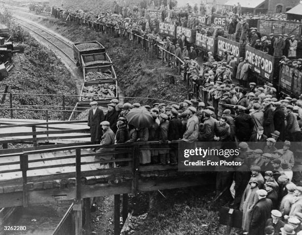 Crowd waits to hear news of 100 miners entombed behind a raging fire in a mine at Gresford Colliery near Wrexham, Wales.