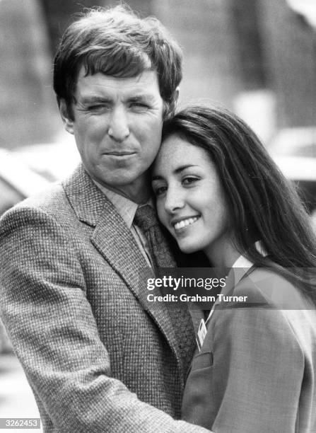 British actor John Nettles as television detective 'Bergerac' embraces co-star Cecile Paoli on location in Jersey.