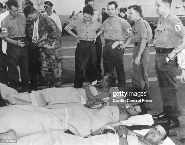 Injured French and British paratroopers aboard the HMS Eagle return to Malta after assault on Port Said in Suez.