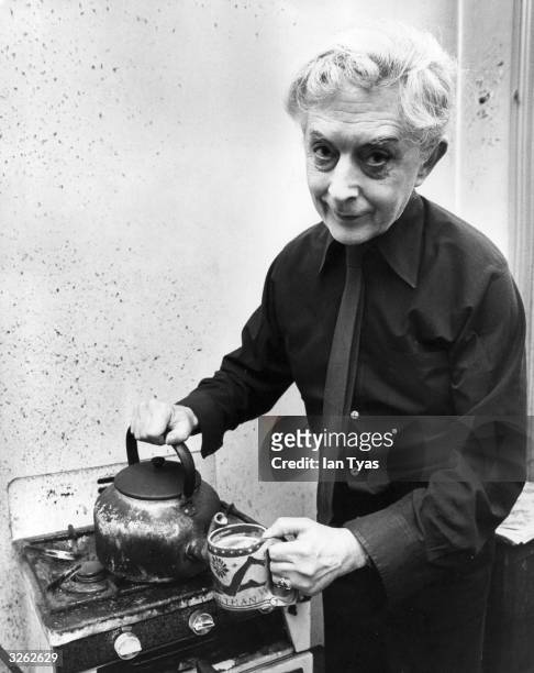 British author Quentin Crisp makes a last pot of tea in the Chelsea bed-sitting room, where he has lived for 41 years, before his move to New York.