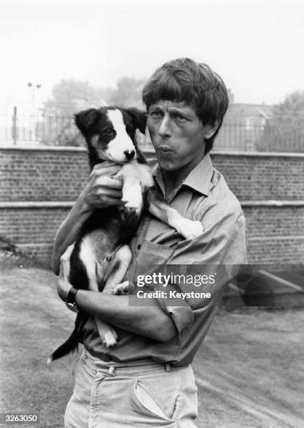 John Noakes whistles to Shep his television pet from the children's show 'Blue Peter'.