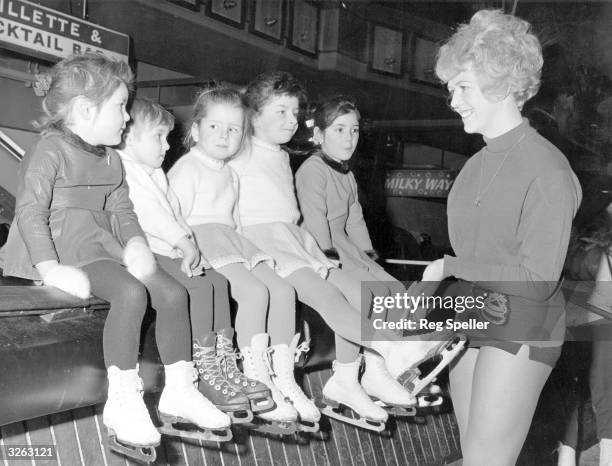 Ice Dance gold-medallist and skating instructress Sylvia Coe checks the skates of young skaters before a lesson at the Silver Blades Ice Rink at...