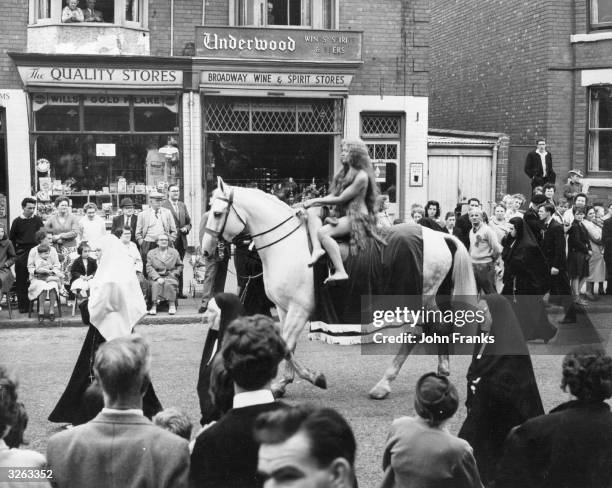Joyce Parker, as Lady Godiva rides through the streets of Coventry during the carnival.