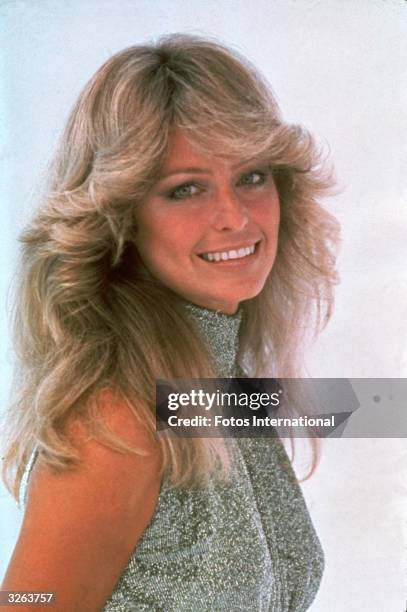 Portrait of American actress Farrah Fawcett, dressed in a high-necked, sleeveless outfit, June 1977.