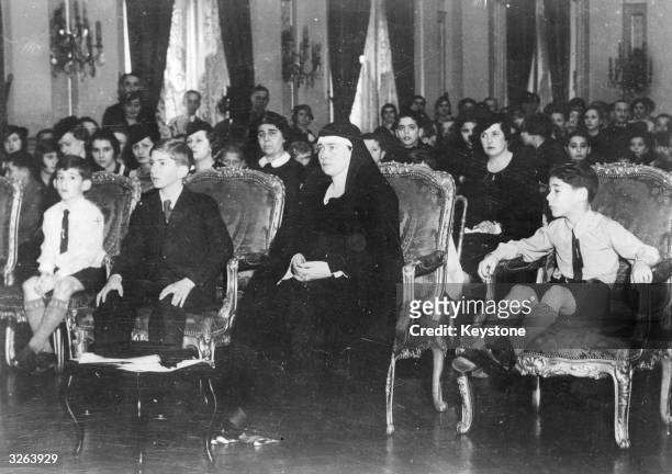 King Peter II , King of Yugoslavia from 1934 -1945 after the assassination of his father, Alexander I. He is seated with his mother, Queen Marie...