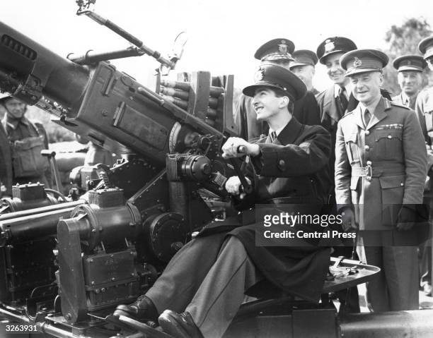 King Peter II , King of Yugoslavia from 1934 -1945, at the controls of a Borfers gun at an AA gun site in the company of Sir Frederick Pile, the...