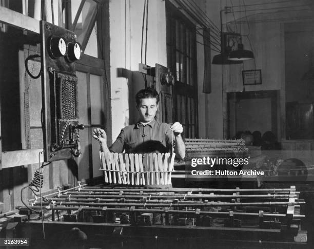 Tableware being silver-plated by the electrolytic method in a Caxlas metalware factory in Brazil