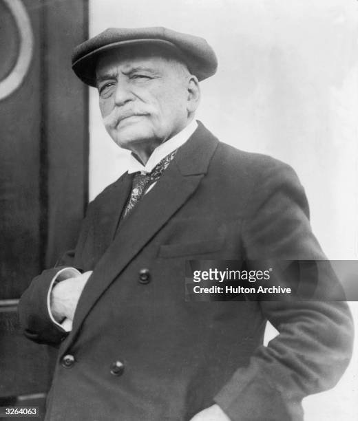 Auguste Escoffier , the French chef otherwise known as 'King Of The Kitchen', is standing in napoleonic pose by a door. He wrote several famous...