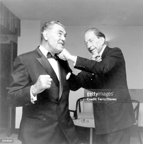 American oil executive, multi-millionaire and art collector J. Paul Getty having a pretend boxing bout with the former heavyweight champion Jack...
