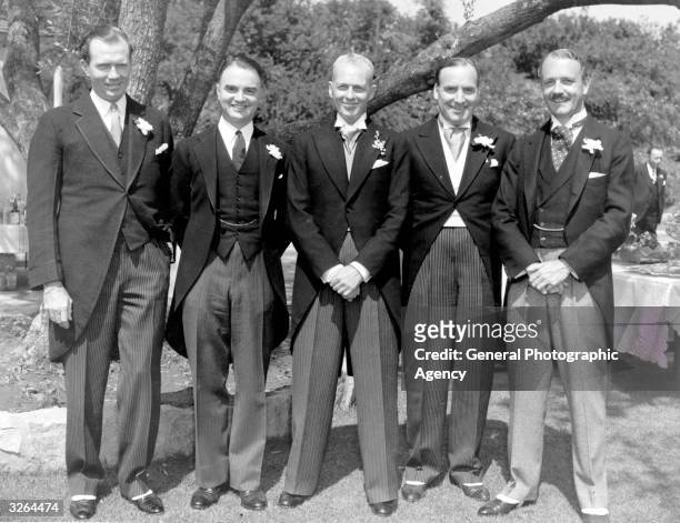 At the wedding reception on the occasion of John Farrow's marriage. From left to right are Ainsworth Morgan, the Hon. A H Tandy , John Farrow, Allan...