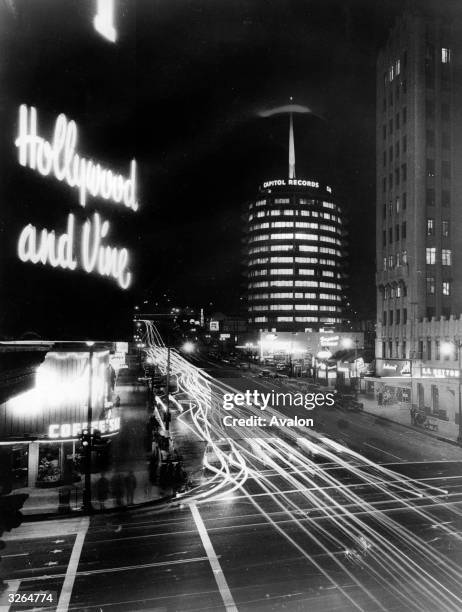 Night-time long-exposure photograph of the American centre of musical recordings at the intersection of Hollywood Boulevard and Vine Avenue in Los...