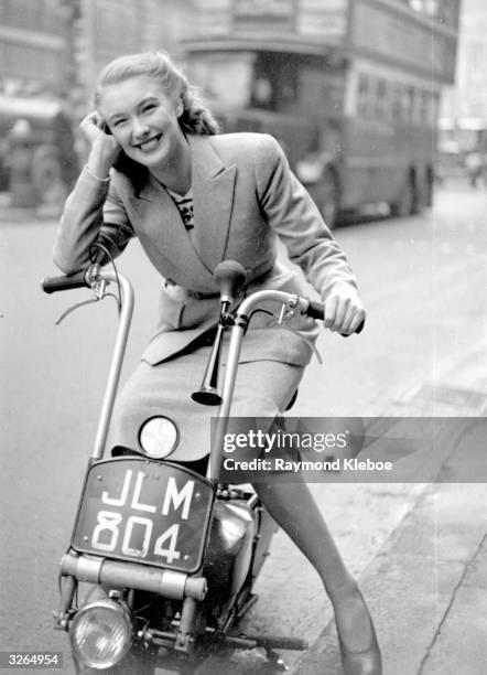 English film actress Susan Shaw riding her scooter. Original Publication: Picture Post - 4518 - The Way Ahead - pub. 1948