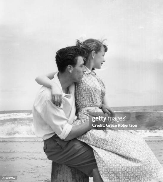 Young couple watch the waves rolling in. Original Publication: Picture Post - 7941 - Butlin's Holiday Camp - unpub.