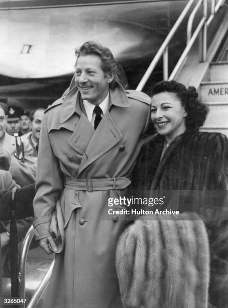American actor and comedian, Danny Kaye , arrives at London Airport with his wife, Sylvia Fine.