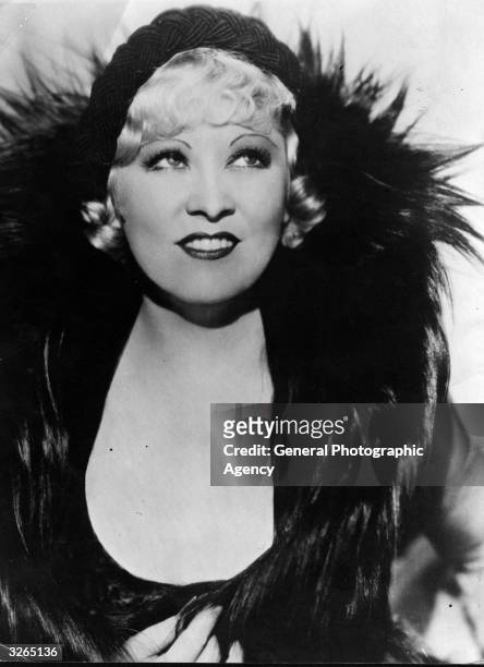 Mae West in her prime, an American leading lady and the archetypal sex symbol who was vulgar, mocking, overdressed and endearing. She wrote her own...