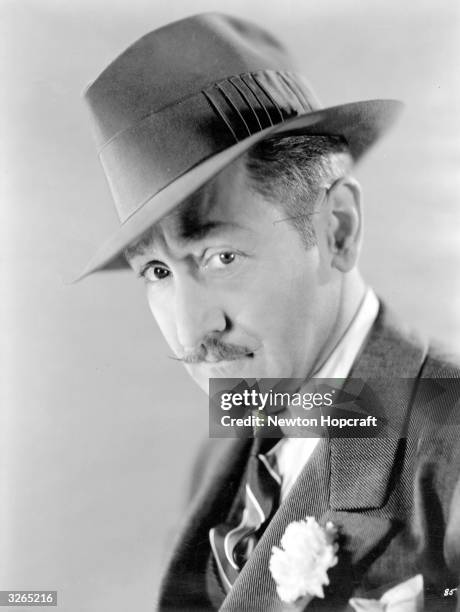 Hollywood actor Adolphe Menjou , who after appearing in Charlie Chaplin's 'A Woman Of Paris,' became typecast as a debonair man of the world.