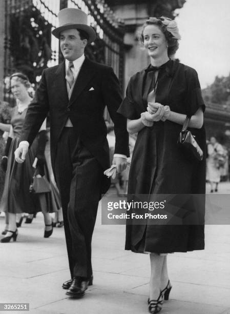 The actress Elspet Gray and her husband actor-manager Brian Rix arrive at Buckingham Palace, London, for a royal garden party, attended by Queen...