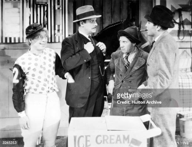 Harpo Marx and Chico Marx in the film 'A Day at the Races', directed by Sam Wood and produced by MGM.