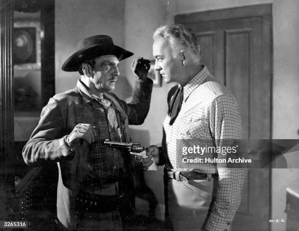 William Boyd , right, plays cowboy Hopalong Cassidy in the film 'The Dead Don't Dream', opposite Francis McDonald . Title: The Dead Don't Dream...
