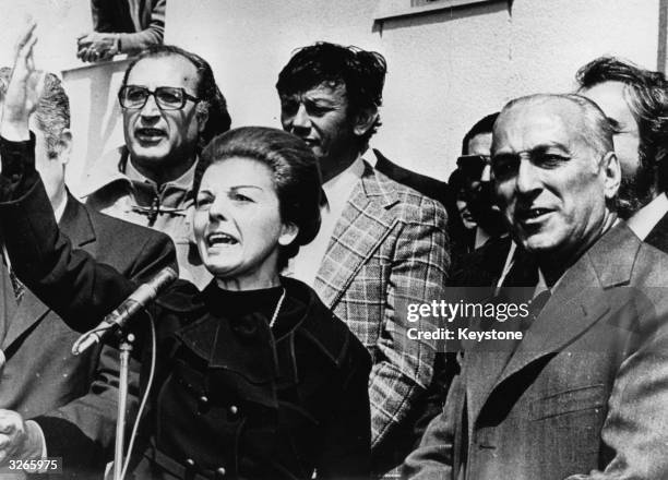 Maria Estela Martinez De Peron, President of Argentina with Dr Jose Lopez Rega, Welfare Minister, on her left addressing an unseen crowd.