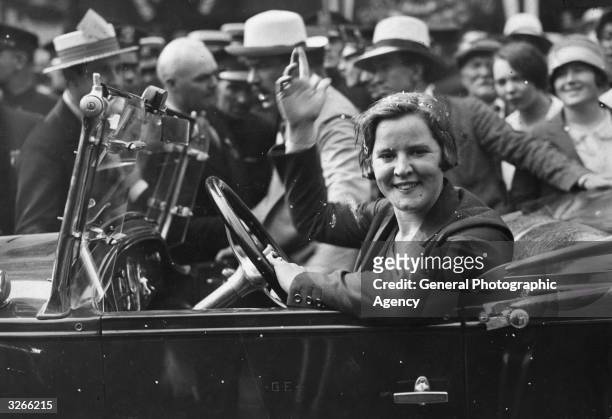 American athlete Gertrude Ederle , the first woman to swim the English Channel, waves from a car, circa 1926.