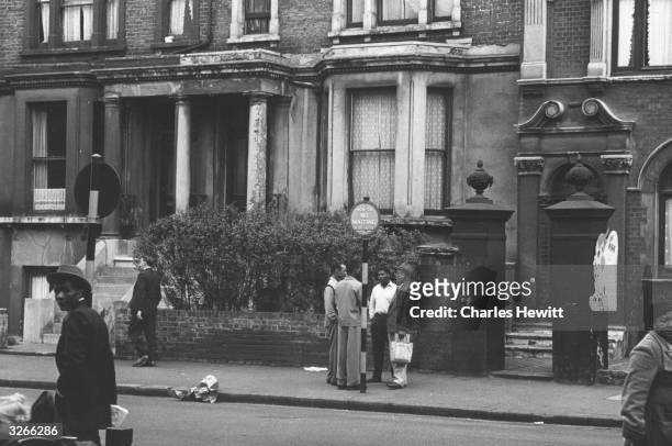 Street scene in Brixton, London, where many immigrants have settled. Original Publication: Picture Post - 6044 - Breeding A Colour Bar - pub. 1952