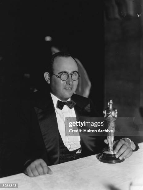 American director and former child actor Norman Taurog at the Academy Awards with the gold statuette or Oscar he has just received for Best Director,...