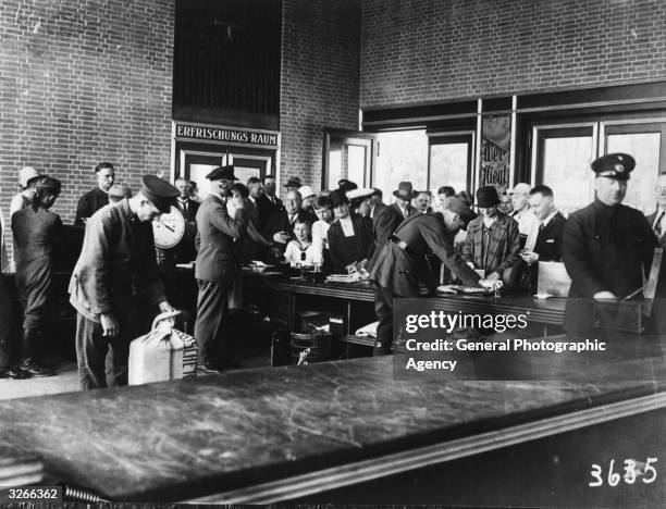 Passengers undergo customs inspection at Berlin's Tempelhof Airport.