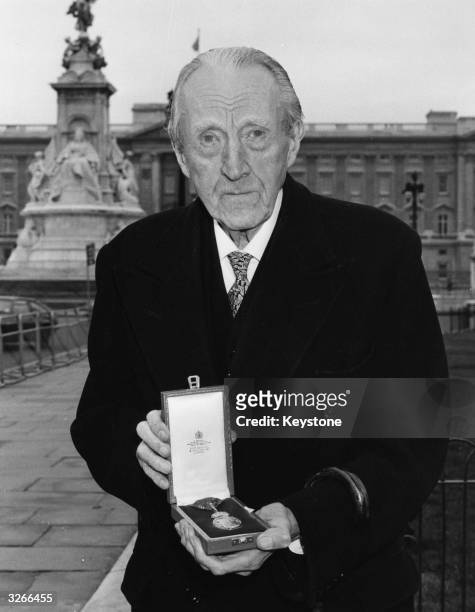 Sir Sacheverell Sitwell with his award from Buckingham Palace for his services to English Literature.