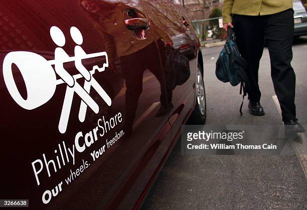Tanya Seaman carries her belongings as she prepares to drive a PhillyCarShare Prius April 8, 2004 in Philadelphia, Pennsylvania. Philadelphia is...