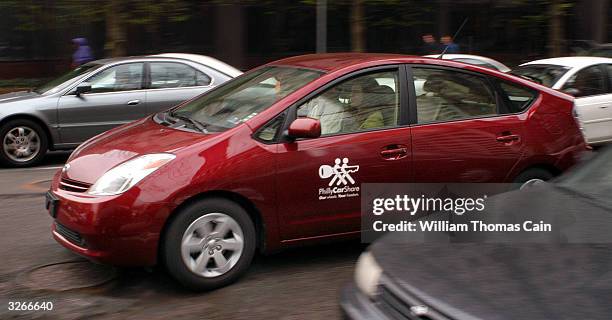 Tanya Seaman drives a PhillyCarShare Prius April 8, 2004 in Philadelphia, Pennsylvania. Philadelphia is selling off hundreds of sedans and sport...