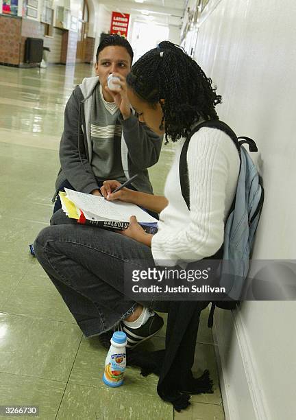High school senior Hector Diaz drinks an organic yogurt smoothie purchased from a vending machine while Hanna Mekonnen does schoolwork at Mission...