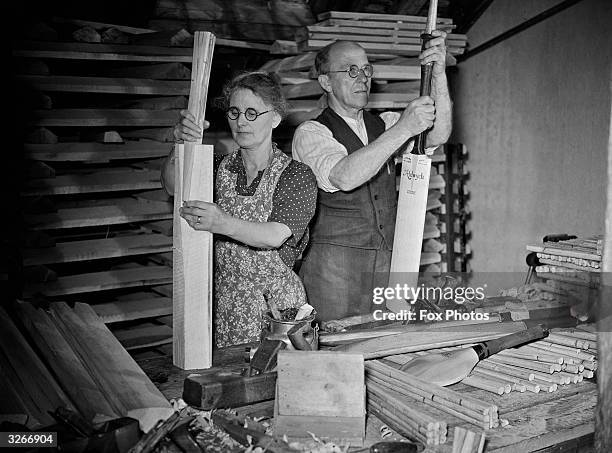Husband and wife team Nellie and William Cochrane manufacturing 'Aldwych' cricket bats at their workshop in Lewes, Sussex, 13th August 1951. Mrs...