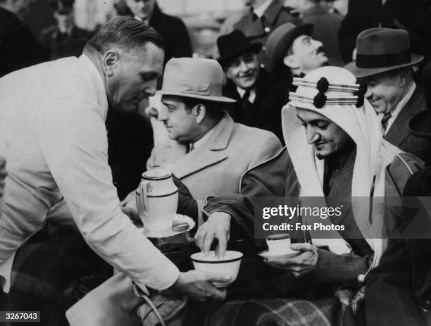 Prince Faisal of Saudi Arabia , later King Faisal, takes a coffee break during a visit to RAF Northolt in London to watch a flying display.