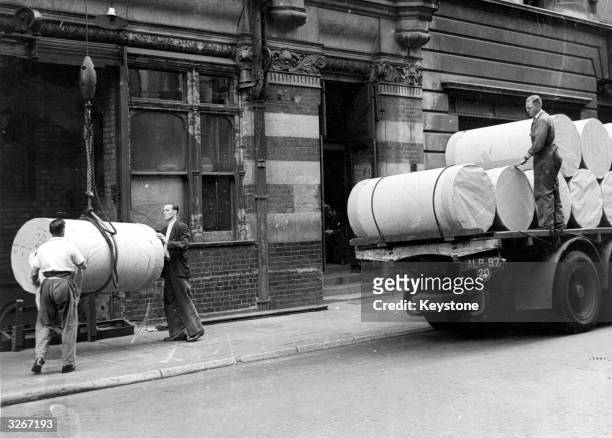 Workmen handle a supply of paper in Fleet Street, the centre for the printing of London's newspapers.