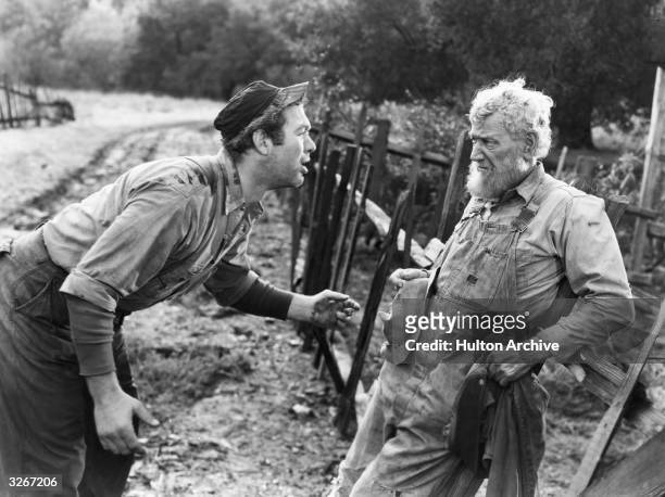 Charley Grapewin the American character actor is being reprimanded by Ward Bond the American actor in a scene from 'Tobacco Road' about the poor...