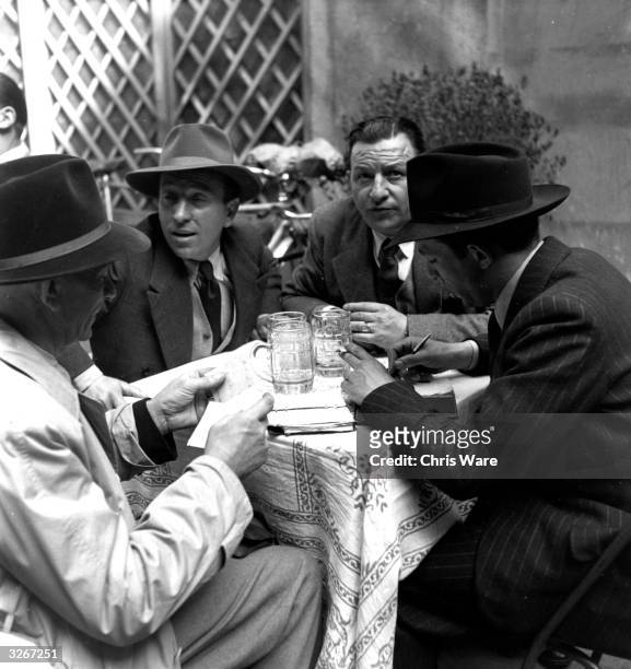 Buyers and sellers take notes and seal a deal with a drink while operating in Milan's black market in the old Merchant's Square of the city.