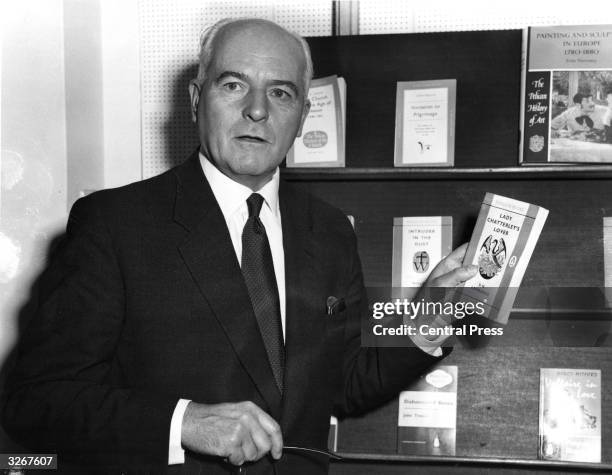 British publisher Sir Allen Lane displays a copy of D H Lawrence's 'Lady Chatterley's Lover', which was the subject of a celebrated obscenity trial....