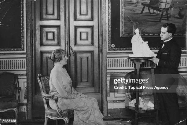 Queen Ena of Spain , wife of Alfonso XIII, posing for a sculptor.