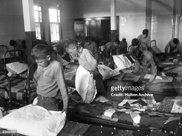 North American Indian children in their dormitory at a Canadian boarding school.