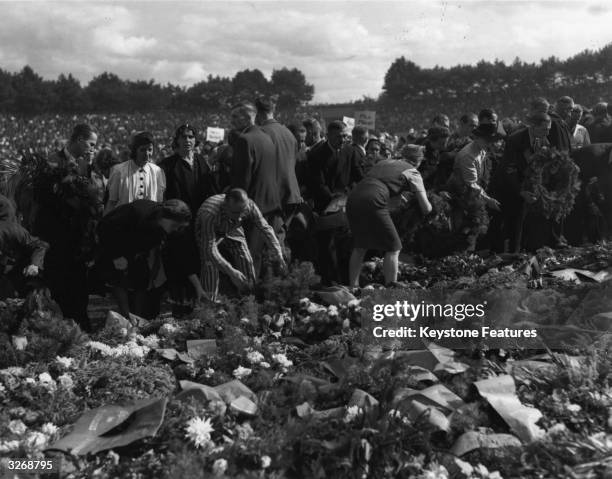 Relatives of the hundreds of Germans who died in the notorious Nazi camps, and former prisoners of the camps, lay wreaths on the ground at the...
