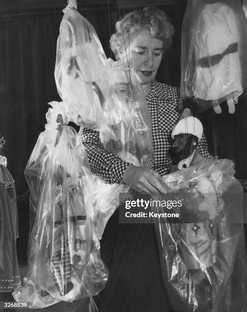 Ann Hogarth, director of 'Master Peter's Puppet Show', packing away the stars of the show in protective bags, before they take part in the...