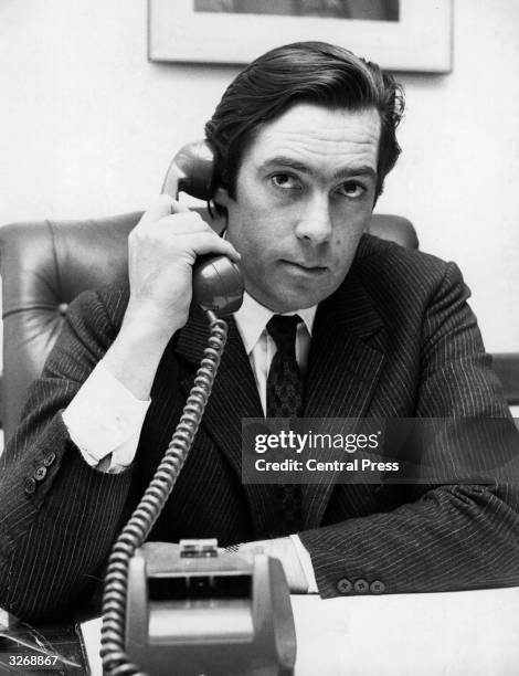 Lord Vestey, joint head of the British Vestey Group shipping company, on the telephone to Buenos Aires, where one of his managing directors, Mr...