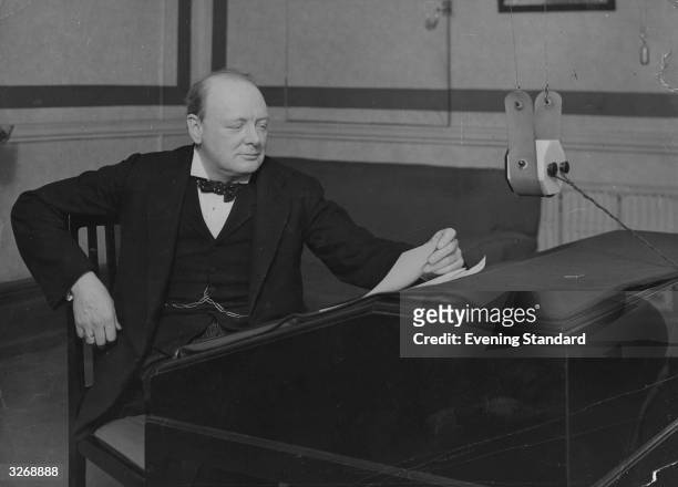 Winston Churchill, Conservative Chancellor of the Exchequer, broadcasting a summary of his budget from a BBC radio studio.