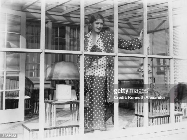 Austro-Hungarian actress Vilma Banky , one of Samuel Goldwyn's stars, gazing through the window of her Malibu beach house.